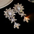 Close-up of sparkling flower drop earrings with oval pearls and clear crystals. - Earrings (Silver Earring Post) / Silver
