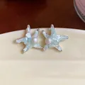 Close-up of starfish stud earrings with pearls and mint green crushed stones - Silver, Green