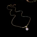Elegant close-up of a sparkling square zircon pendant on 14K gold plated necklace chain - Gold
