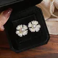 Detailed view of floral stud earrings with pearl center and zircon accents in box - Silver Post Flower (HE32508) / Silver