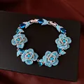 Close-up detail of a vintage silver flower bracelet adorned with sparkling blue crystals - Flower Clasp Style (HB6041) / 20cm Length / Silver Blue