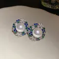 Detailed view of vintage-style pearl stud earrings with green and blue zircons - Stud Earrings (925 Silver Pin) / Silver-Green