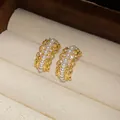 Vista detallada de elegantes pendientes en forma de C dorados con perlas y cristales. - Estilo Perla de Encaje / Dorado