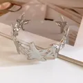 Close-up of silver metal starfish-shaped open cuff bracelet with glossy finish. - Silver