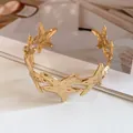 Close-up of gold metal starfish cuff bracelet detail against a minimalist background - Gold