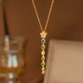 Close-up of a gold Y-necklace featuring a star pendant and multi-color round zircon stones. - Pentagram Colorful Zirconia Style (9491) / Gold