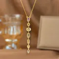 Detailed close-up of a gold-plated Y-shaped tassel necklace with colorful zircon stones - Colorful Zirconia Long Style (9404) / Gold