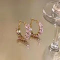 Macro detail of pink marquise zircon stones on gold-plated wheat ear hoop earrings. - Ear Buckle / Gold-Pink