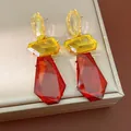 Detail of oversized irregular resin earrings in amber and yellow with silver needles - Irregular Geometric Splicing (HE33887) / Yellow-Coffee