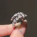 Close-up of a sparkling silver snake ring with square zircons and luxury finish - Snake Style (HR1098) / Silver