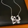 Detail shot of silver butterfly pendant featuring colorful zircon stones and floral designs - Butterfly Pendant Necklace / Silver - Rainbow