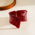 Close-up detail of dark red marbled resin irregular geometric twisted cuff bracelet - Burgundy