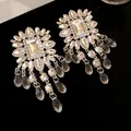 Close-up of elegant chandelier earrings with sparkling rhinestones and teardrop dangles - Silver (Silver Pin)