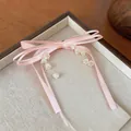 Dettaglio di un fermaglio per capelli a fiocco rosa con ciondoli di mughetto in un vassoio. - Clip a Becco d'Anatra (Pezzo Singolo) / Rosa