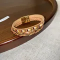 Close-up view detail of Bohemian multi-layer braided leather bracelet with gold clasp - Gold Brown