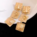 Vintage gold-toned square drop earrings with embossed ear and nose anatomical details - Gold