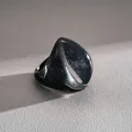 Macro view of an exaggerated dark resin fan-shaped ring with galaxy shimmer effect - Fan Shape Style / Black