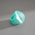 Close-up of a teal pearlescent resin fan-shaped ring with geometric design - Fan Shape Style / Lake Blue