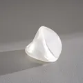 Macro view of a white resin fan-shaped ring showing pearlescent texture and shadow - Fan Shape Style / White
