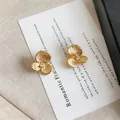 Exquisite 3D gold camellia flower stud earrings featuring a central sparkling zircon - Camellia Pattern / Gold