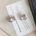 Elegant silver flower stud earrings featuring textured petals and a sparkling center stone - Camellia Pattern / Silver