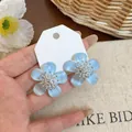 Hand-held sweet light blue resin flower stud earrings with shimmering zircon centers - 925 Silver Post Style / Blue