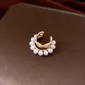 Elegant double-layer gold plated ear cuff featuring white pearls and sparkling cubic zirconia - Gold