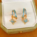 Macro detail of elegant gold star pendant earrings with vibrant blue turquoise inlay - North Star Pendant (HE34256) / Gold with Blue