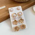 Close-up detail of a four-pair vintage gold-tone earring set featuring pearls and floral motifs - 10-Piece Set / Gold