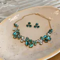 Close-up view of an elegant teal and white flower jewelry set including necklace and earrings. - Necklace and Earrings Set / Green
