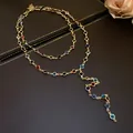 Close-up of a vintage double-layered Y-shaped necklace with colorful glass beads and gold finish - Gold