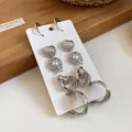 Detail view of silver-toned metal earring set with heart studs and hoop designs - 10 Pieces Set (Studs & Hoops) / Silver