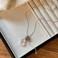 Close-up of a dalmatian jasper grape cluster necklace in a white jewelry tray - Spot Stone Grape Cluster / Silver