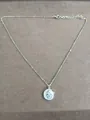 Elegant silver chain necklace featuring a round zircon and resin star and moon pendant - Silver