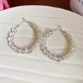 Detailed view of handmade clear glass bead hoop earrings with silver needles - Silver Post - White - Yellow