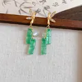 Detailed view of elegant gold bamboo leaf earrings with green resin bamboo joint tassels. - New Chinese Bamboo Tassel (HE34239) / Gold, Green