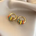 Close-up of colorful enamel hoop earrings with gold-plated finish on silk background. - Hoop-Gold-Multicolor (Real Gold Plated)
