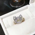 Detailed view of elegant silver bow-knot ring with hollow filigree design in box - Bow Hollow Style (HR3328) / Silver