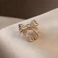 Elegant golden open ring featuring an intricate hollow bow design with lattice texture - Bow Hollow Style (HR3328) / Light Coffee Gold