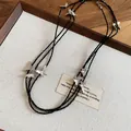 Close-up detail of a layered necklace featuring black beads and silver butterfly charms - Butterfly Layered Necklace / Black