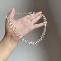 Close-up of a clear heart-shaped beaded necklace with vibrant colorful seed bead accents - Transparent Multicolor