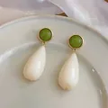 Detail view of minimalist resin teardrop earrings with green stud and cream drop. - Teardrop Stud Earrings (HE32543) / White-Green