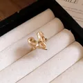 Close-up of a minimalist gold melted heart ring displayed in a cream jewelry tray - Ring / Gold