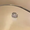 Silver ear cuff with heart-shaped cubic zirconia on a warm reflective surface - Heart Zirconia Style (5#)