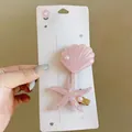 Detailed view of a pink shell and starfish hair clip with elegant pearl accents - Starfish Scallop Duckbill Clip / Two-Piece Set / Pink