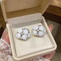 Elegant white rose flower stud earrings with sparkling crystals in a jewelry box - Silver White