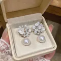 Elegant floral pearl drop earrings with sparkling rhinestones in a luxury cream jewelry box - White