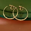 Detail view of 14K gold plated faceted bead hoop ear clips with clip-on back mechanism. - Clip-On Earrings / Gold