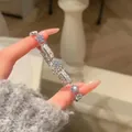 Detail view of a dainty Korean style silver flower bracelet with sparkling zircons - Silver-Blue