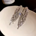 Elegant silver-tone geometric tassel earrings with sparkling rhinestones in a macro detail view - Silver Earring Post-White